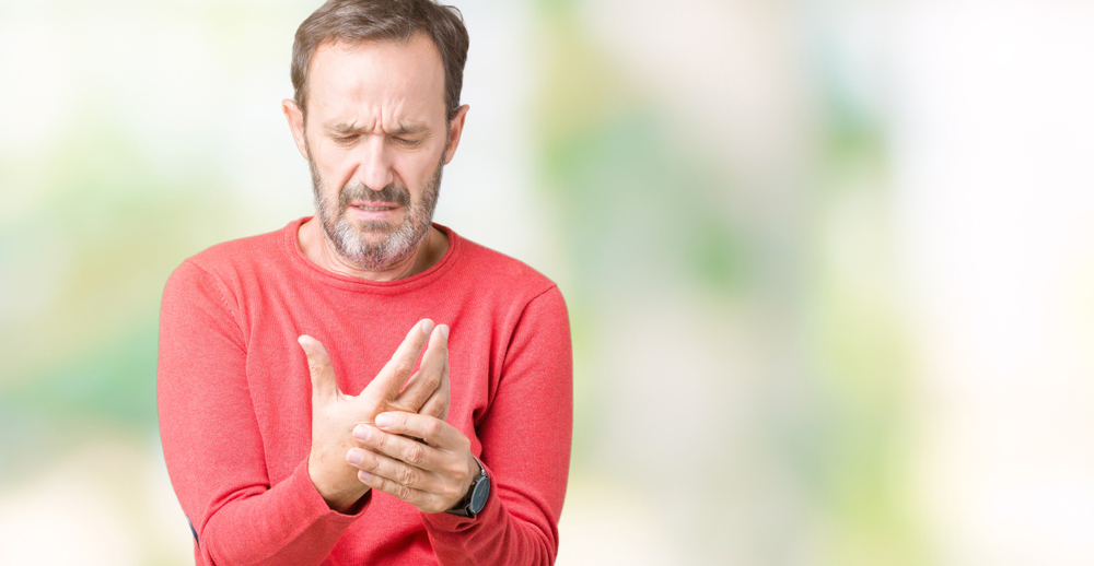 A man with arthritis in his hand experiences pain